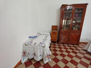 a bedroom with a table with a blanket on it at Casa Gelsomino by Holiday World in Donnalucata