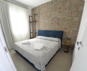 a bedroom with a large bed with a blue head board at Riflessi sul Plemmirio in Plemmirio +24 photos