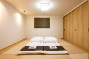a bedroom with two beds in a room at Irodori Hotel TEN in Fukuoka +33 photos