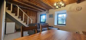 a dining room with a table and a staircase at Holiday house in Supetarska Draga - Insel Rab 36083 in Supetarska Draga +6 photos