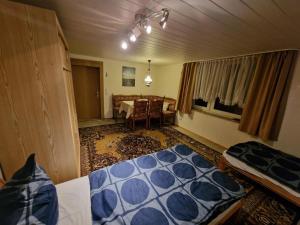 a bedroom with a bed and a table in it at Messe Apartments Hannover in Hannover +3 photos