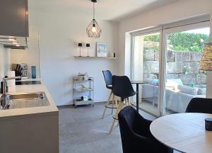 a kitchen with a table and chairs and a window at Ankerplatz in Lindau +11 photos