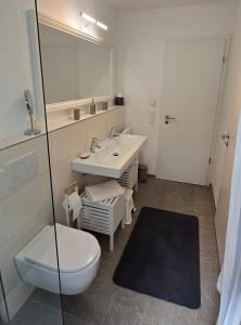 a bathroom with a sink and a toilet and a mirror at Ankerplatz in Lindau
