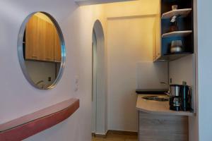 a small kitchen with a sink and a mirror at Elisabeth in Vourvourou +11 photos