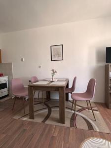 a dining room with a table and two chairs at Apartmani Dana in Vranje