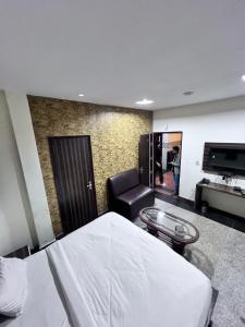 a bedroom with a bed and a chair and a television at Hotel Airport residency in Jaipur