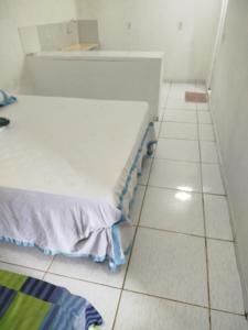 a room with a bed and a tiled floor at Tô em Casa Hospedagem in Jijoca de Jericoacoara +9 photos