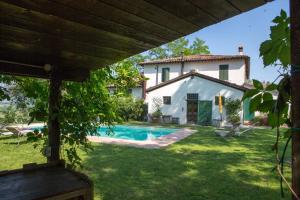 an external view of a house and a swimming pool at Locanda Della Fortuna in Faenza