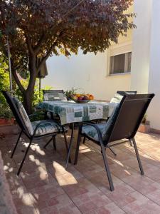 a table with two chairs and a table with fruit on it at Apartment Ivan in Rovinj