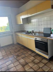 a kitchen with a sink and a stove at Schöne Monteur- Wohnungen teilweise mit Balkon oder Terrasse in Ahlen