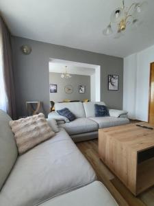 a living room with a couch and a table at Holiday Central House in Sarajevo
