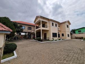 a large house with a brick driveway in front of it at Ibra's Villa in Trofwi