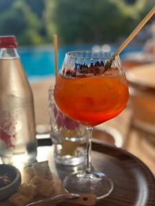 a drink in a glass sitting on a table at Hôtel Palombaggia in Porto-Vecchio