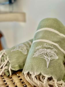 a pillow with a tree on it sitting on a table at Hôtel Palombaggia in Porto-Vecchio
