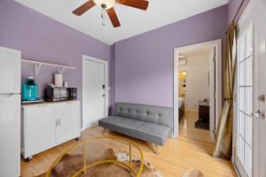a living room with a couch and a ceiling fan at Cozy Backhouse Stay – Sleeps 2 Beverly Hills Adj in Los Angeles
