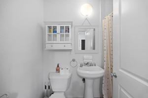 a white bathroom with a sink and a toilet at Cozy Backhouse Stay – Sleeps 2 Beverly Hills Adj in Los Angeles +9 photos