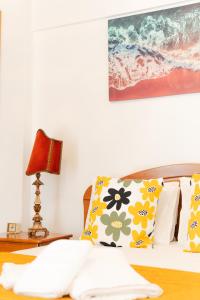 un letto con un cuscino e una lampada su un tavolo di Sea & Soul a Costa da Caparica