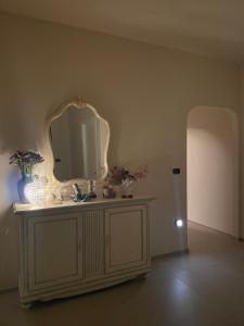 a bathroom with a sink and a mirror on the wall at Casa Manu in Gallipoli