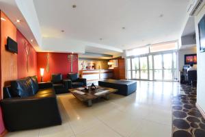a living room with couches and a coffee table at La Mision Posadas in Posadas