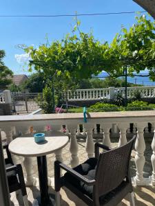 a white railing with a table and chairs on a balcony at Room Josip in Senj