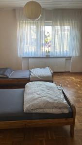 two beds in a room with two windows at Schöne Monteur- Wohnungen teilweise mit Balkon oder Terrasse in Ahlen