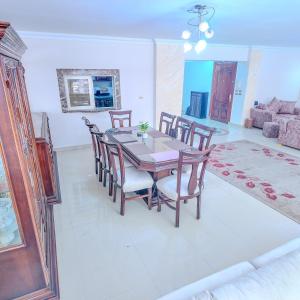 a dining table and chairs in a living room at Big Flat in Dokki Twin Room Private Bathroom in Cairo