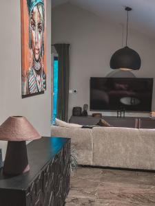 a living room with a couch and a flat screen tv at Holiday Home Sofia - quiet village&quick highway close to Biograd na Moru and Zadar in Benkovac