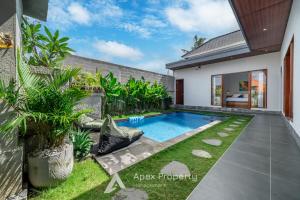 a swimming pool in the backyard of a house at Traditional Villa Astina Cemagi in Cemagi +11 photos