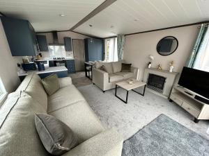 a living room with a couch and a fireplace at Beckys Lodge in Wilberfoss