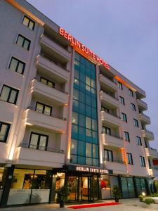 a white hotel with a sign on the front of it at Berlin Suite Hotel Trabzon in Trabzon