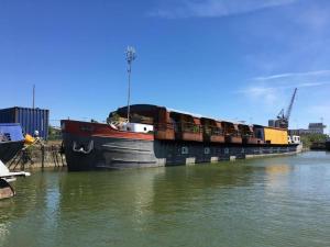 a large cargo ship is docked in the water at Superbe Péniche En Centre Ville in Bordeaux