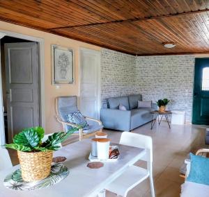 a living room with a couch and a table at Menƴ's Azure Escape in Dhíkella