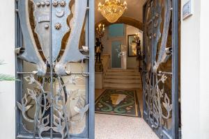 a door leading to a hallway with a chandelier at Palazzo Gallo Resort in Gallipoli