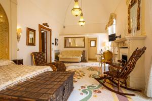 a bedroom with a bed and a living room at Palazzo Gallo Resort in Gallipoli