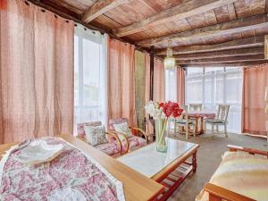 a bedroom with a bed and a vase of flowers on a table at Casa Ondare Etxea by Clabao in Abínzano