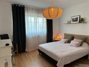 a bedroom with a bed and a large window at L œil de sangatte in Sangatte