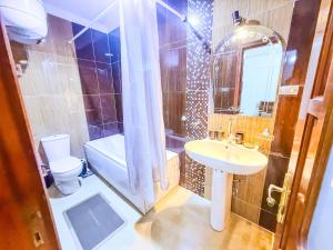 a bathroom with a sink and a toilet and a mirror at Big Flat in Dokki Twin Room Private Bathroom in Cairo +50 photos