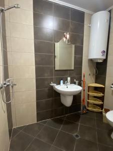 a bathroom with a sink and a mirror at Belchevi Apartments in Burgas City +36 photos