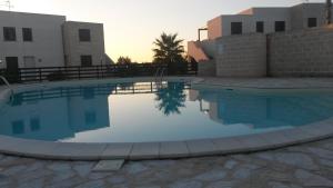 a large swimming pool in front of a building at Casa Vacanze Lido Burrone in Favignana