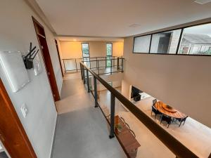 an overhead view of a staircase with a table and a refrigerator at Luxuosa Casa em Bananeiras in Bananeiras