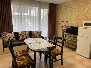 a living room with a table and a couch at Belchevi Apartments in Burgas City