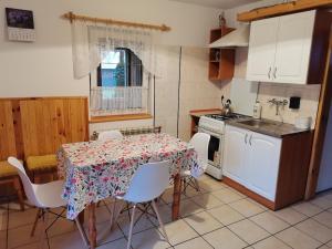 a kitchen with a table and chairs and a table and a table and a kitchen at Agroturystyka Pod Olchami in Lipowiec +10 photos