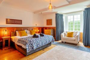 a bedroom with a bed and a chair at Finest Retreats - The Old Rectory in Tring