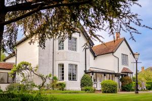 a white house with a tree at Finest Retreats - The Old Rectory in Tring