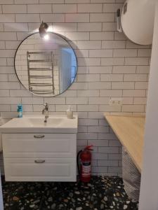 a bathroom with a sink and a mirror at Vilimiškės Apartamentai in Palanga +12 photos