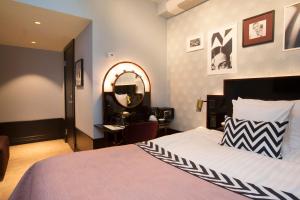 a bedroom with a bed and a desk and a mirror at Haymarket by Scandic in Stockholm +121 photos