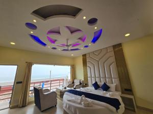 a bedroom with a large bed and a large chandelier at Ricardo Beach Resort in Mandarmoni +37 photos