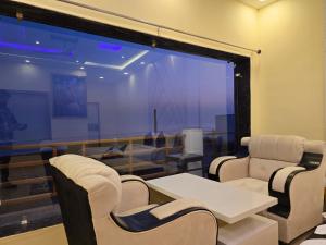 a conference room with a table and chairs and a large window at Ricardo Beach Resort in Mandarmoni