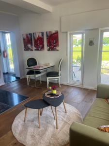 a living room with a couch and a table at Ferienwohnung Waldseite in Bad Bentheim
