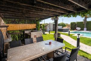 a patio with a table and chairs and a pool at Evan by Briskva in Poreč